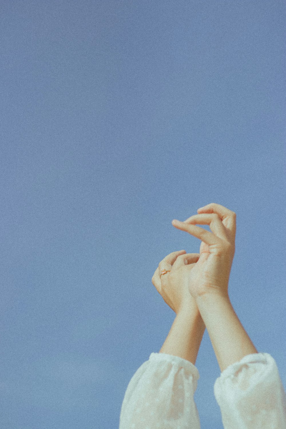 persons hand on blue sky