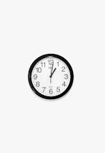 black and white round analog wall clock at 10 10