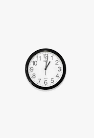 black and white round analog wall clock at 10 10