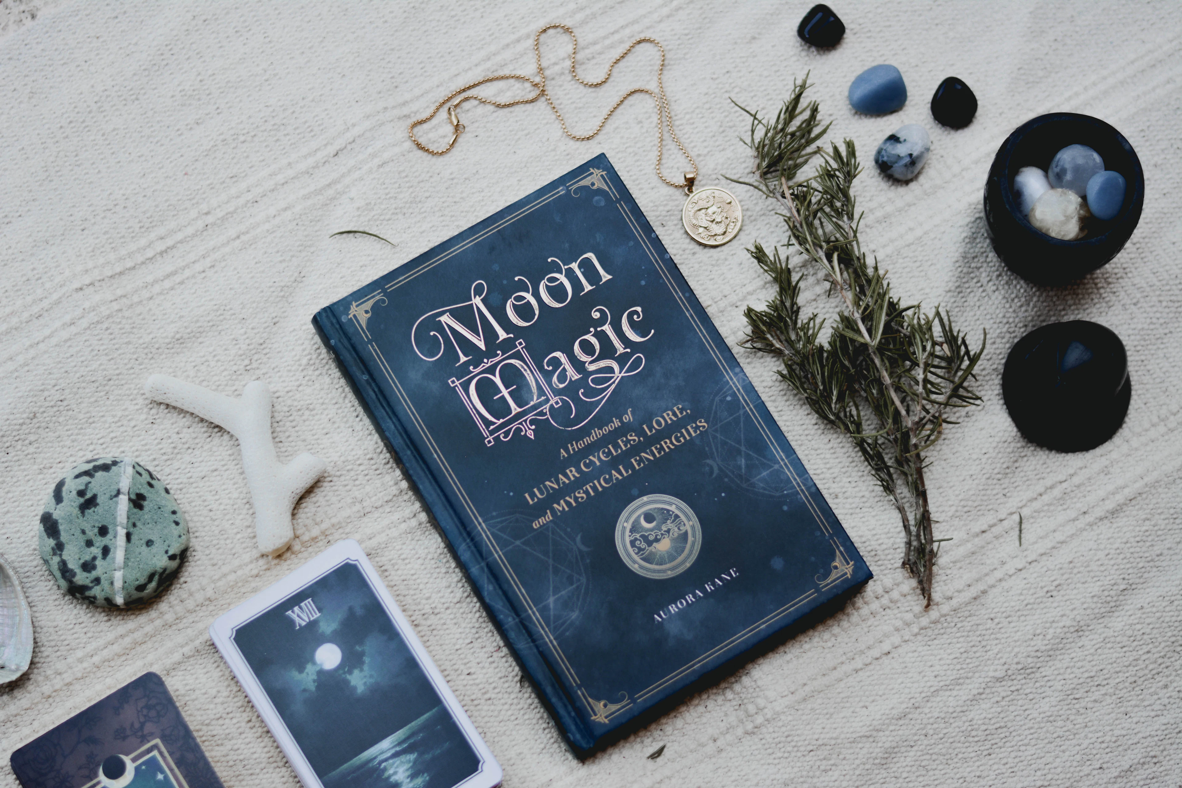 Moon magic book on a Wicca altar with candles and ritual items