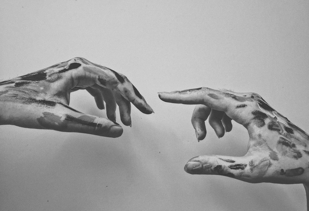 grayscale photo of human hands