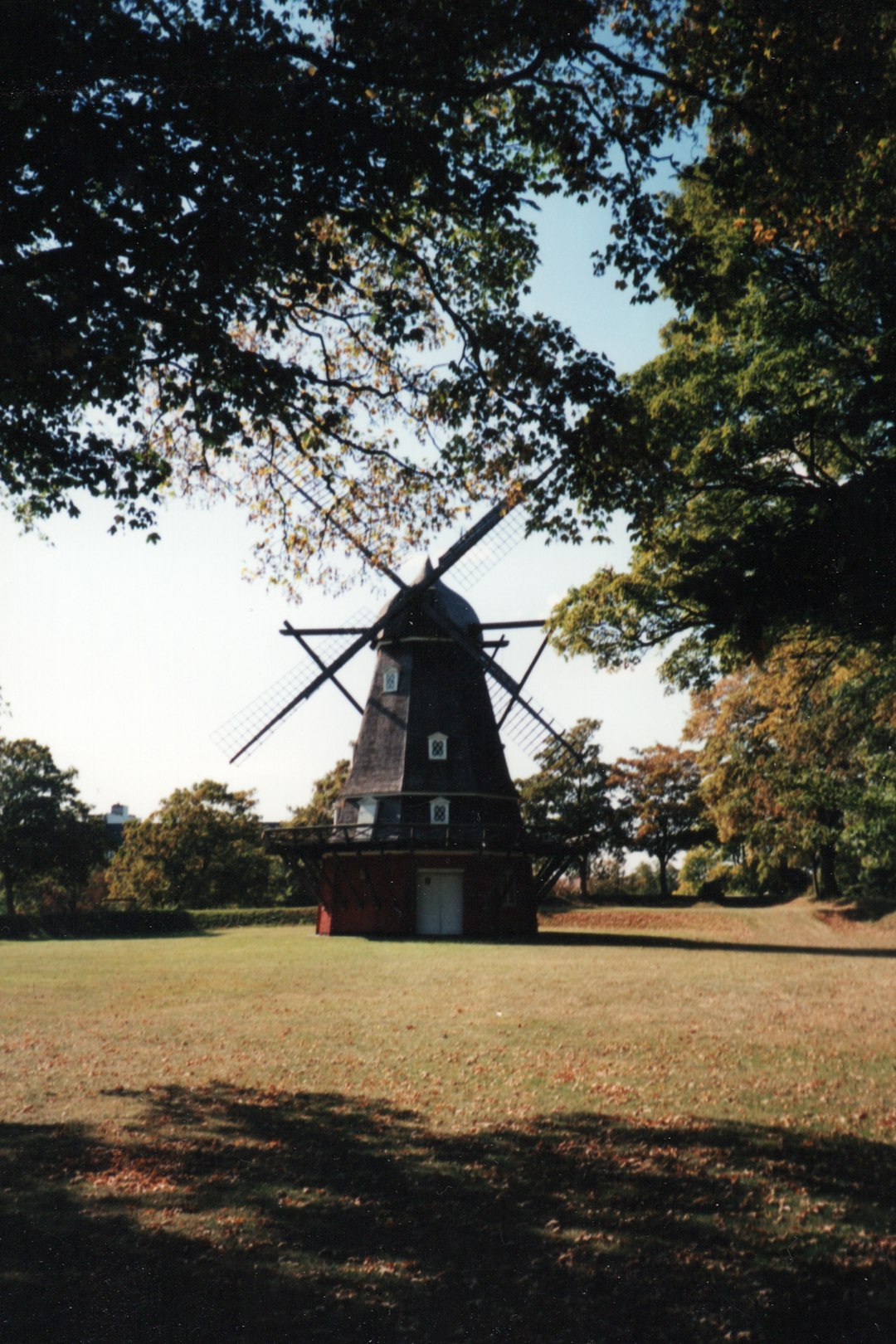 black and red windmill on green grass field during daytime