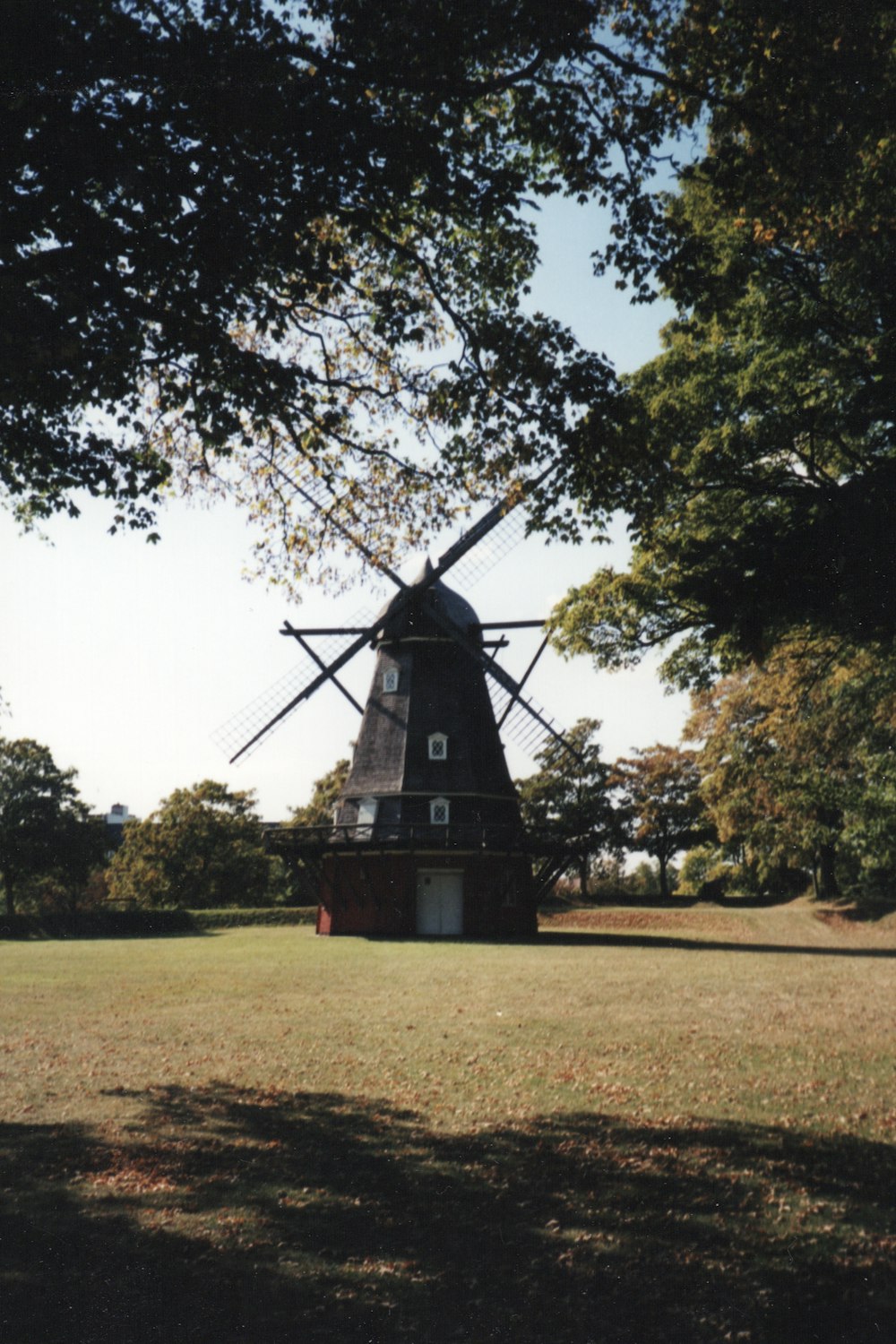 black and red windmill on green grass field during daytime