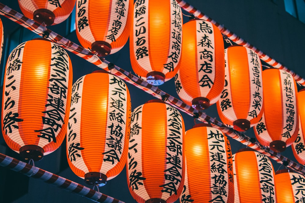 orange paper lanterns on black metal frame