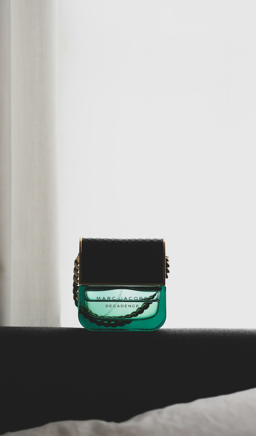 green and black perfume bottle