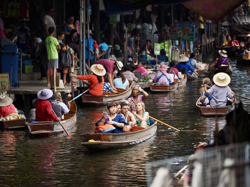 people riding on boat on river during daytime