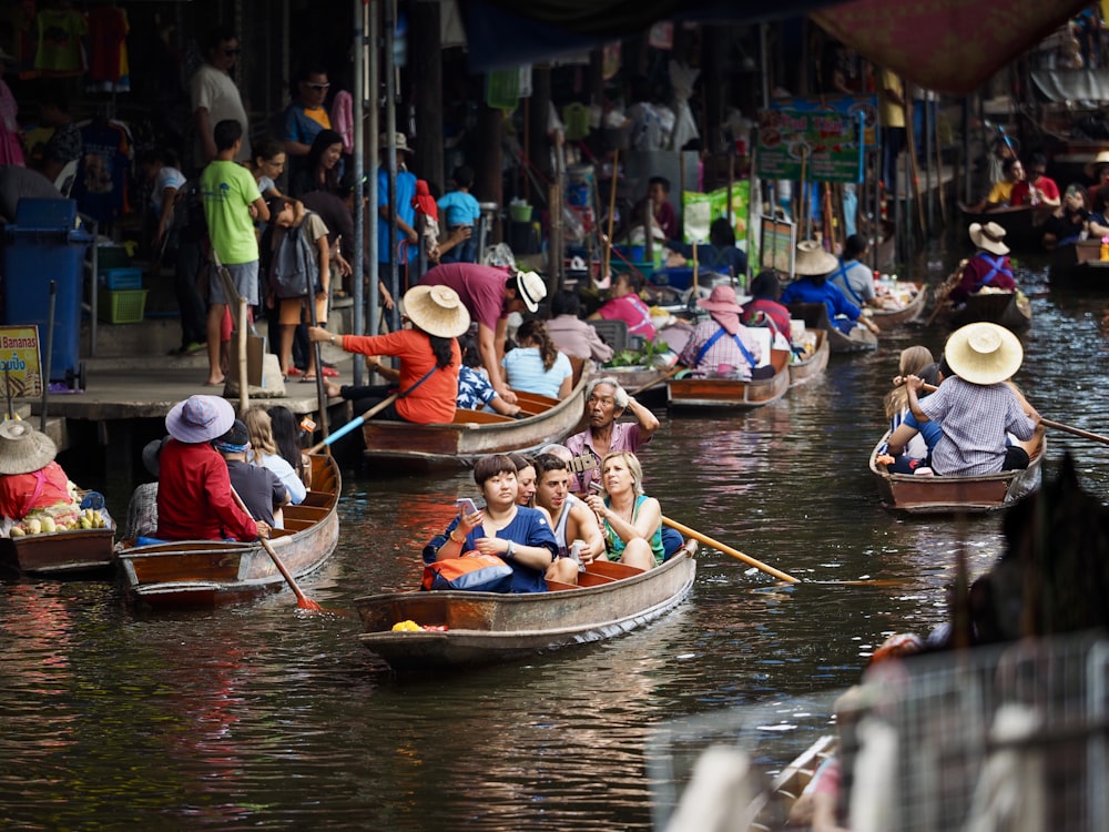 people riding on boat on river during daytime