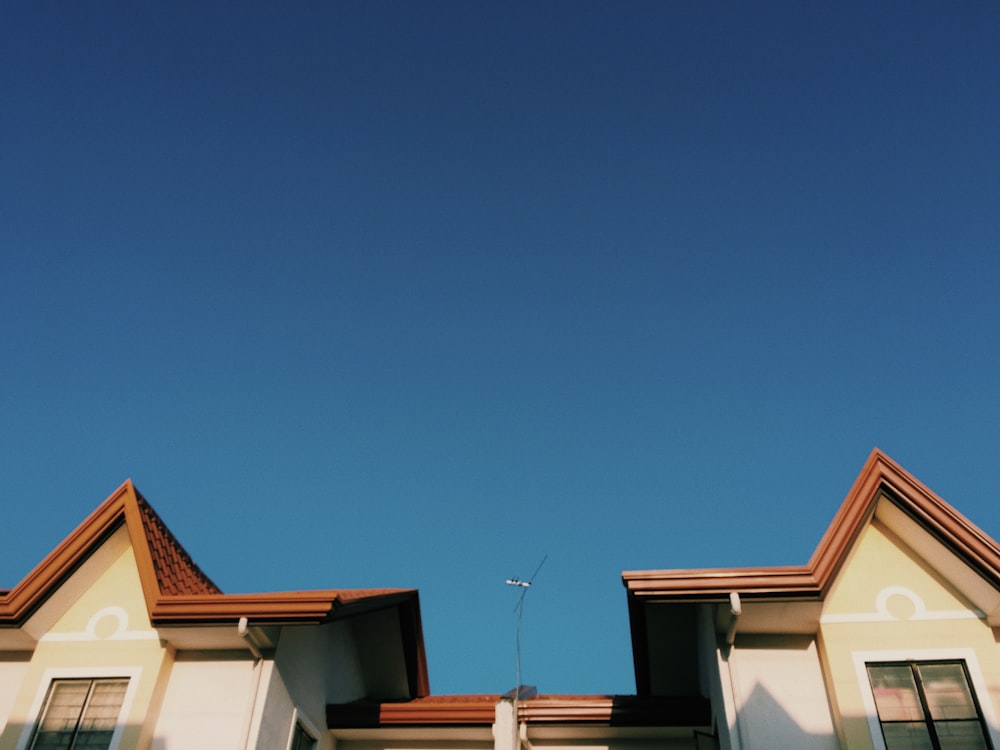 brown and white concrete house under blue sky during daytime