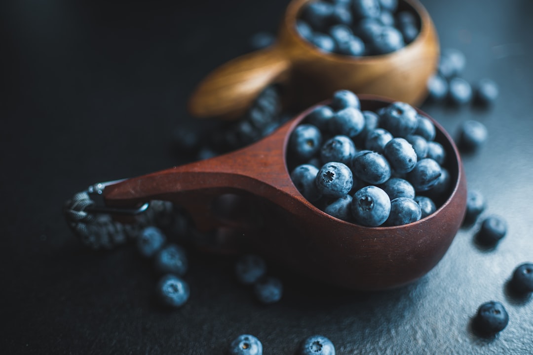 black berries on brown wooden bowl