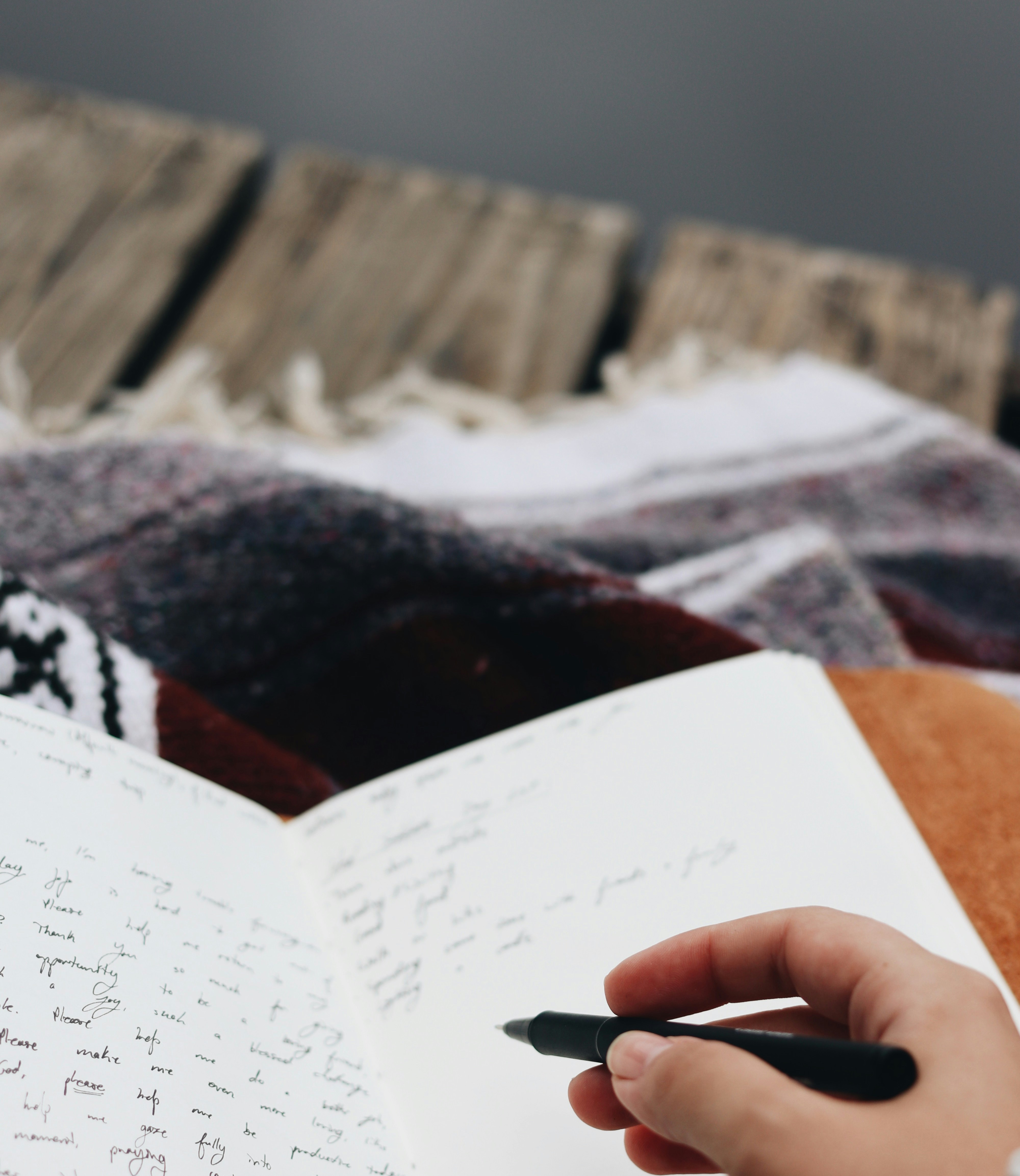 Person's hand writing in a journal