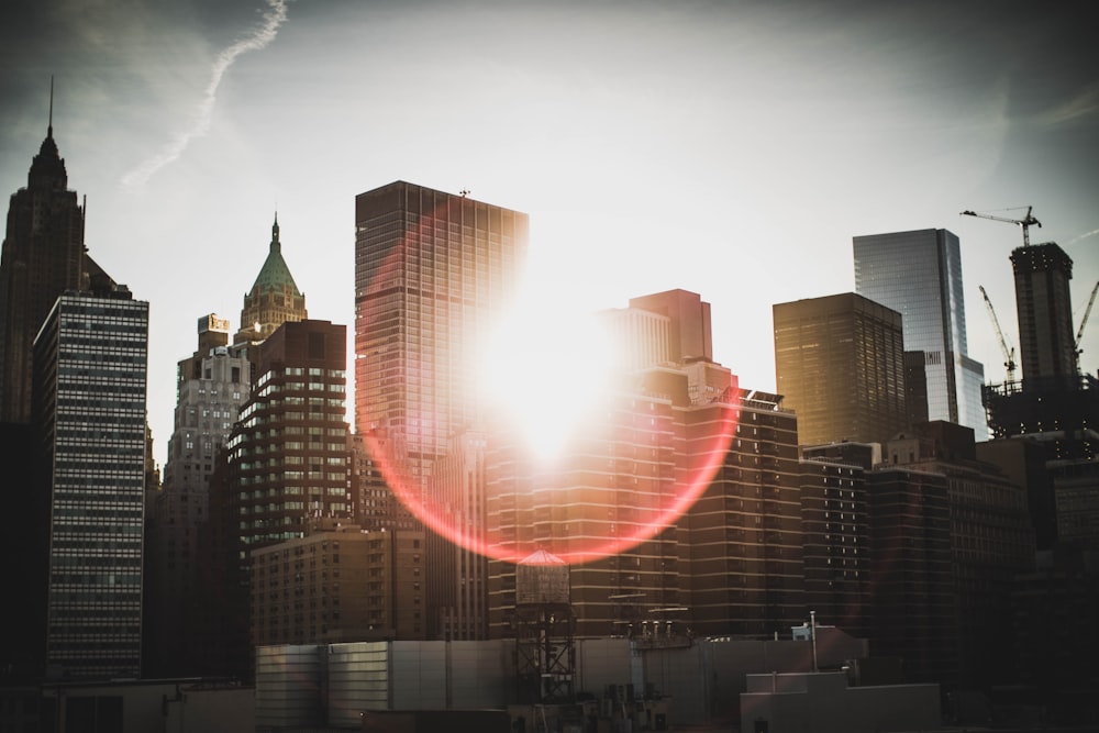 high rise buildings under white clouds during daytime