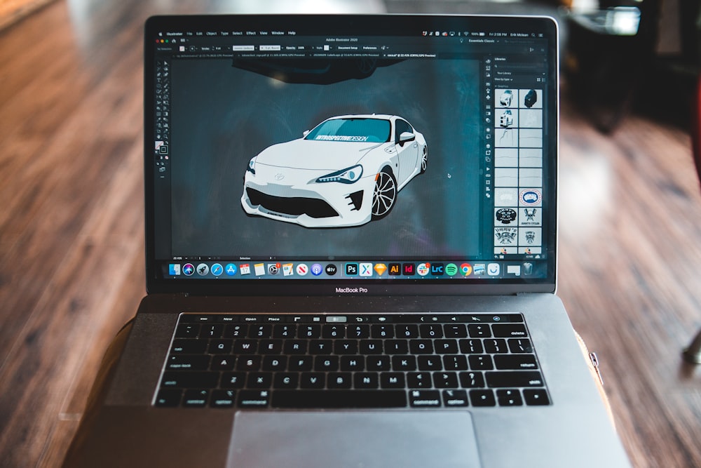 macbook pro displaying white and black sports car