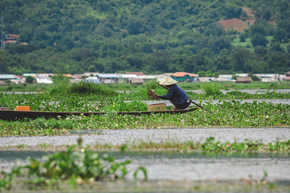 person in black shirt fishing on lake during daytime