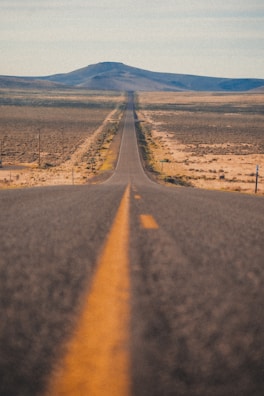 A long road stretching through a vast landscape.