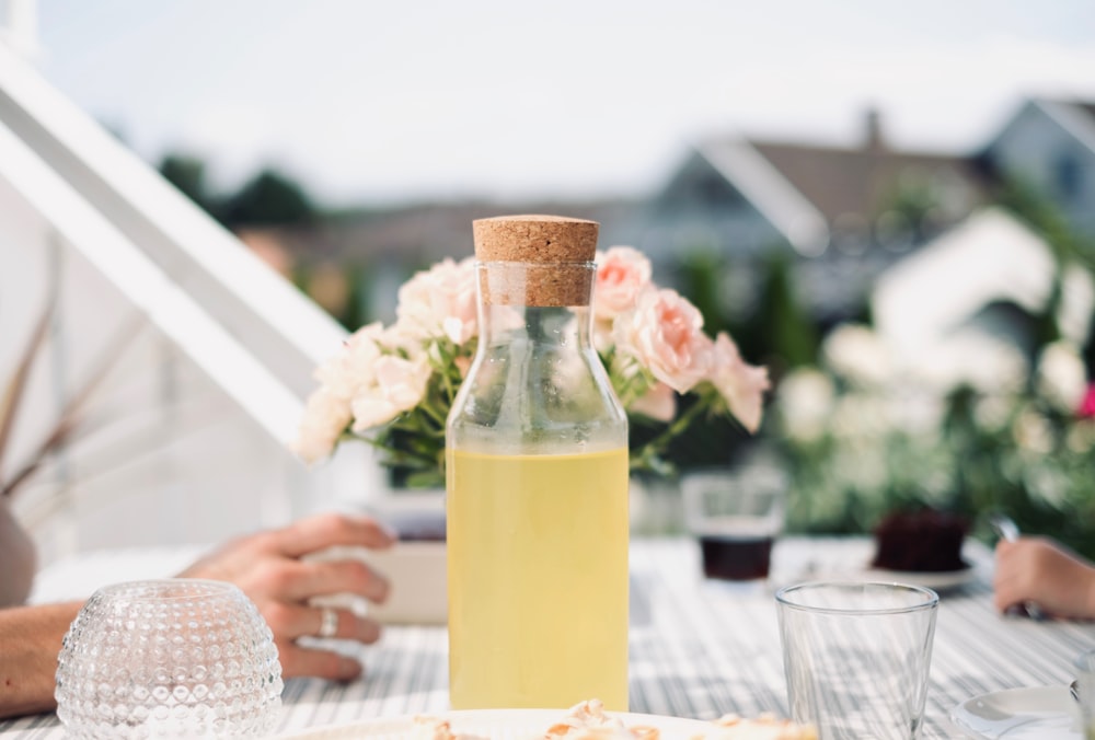 clear glass bottle with yellow liquid