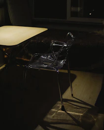 Dark industrial-style wooden and metal chair in a moody room.