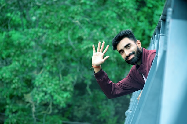 man in black long sleeve shirt raising his hand