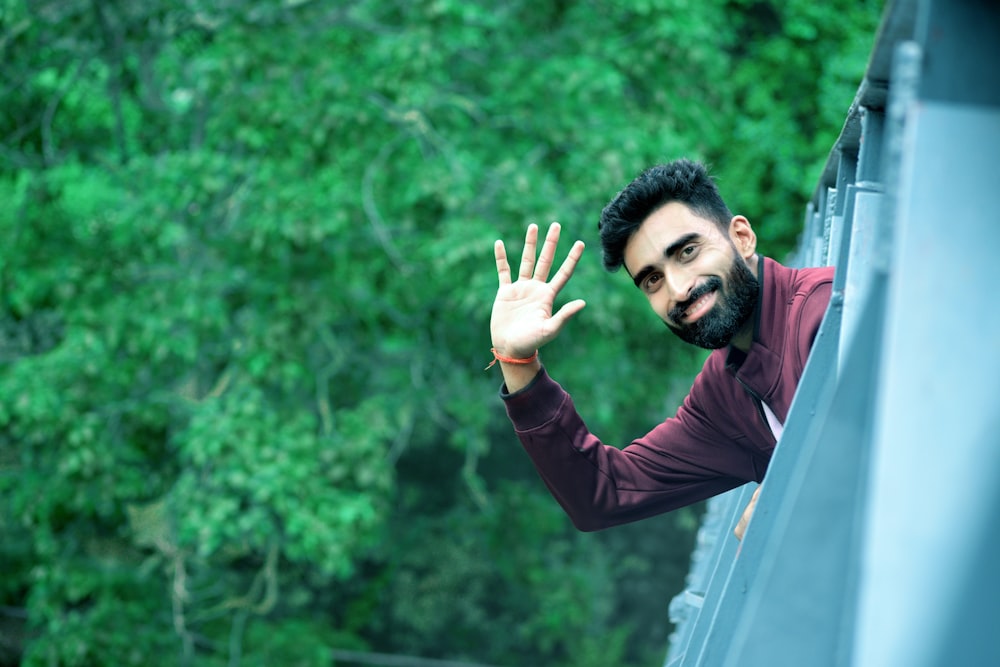 man in black long sleeve shirt raising his hand