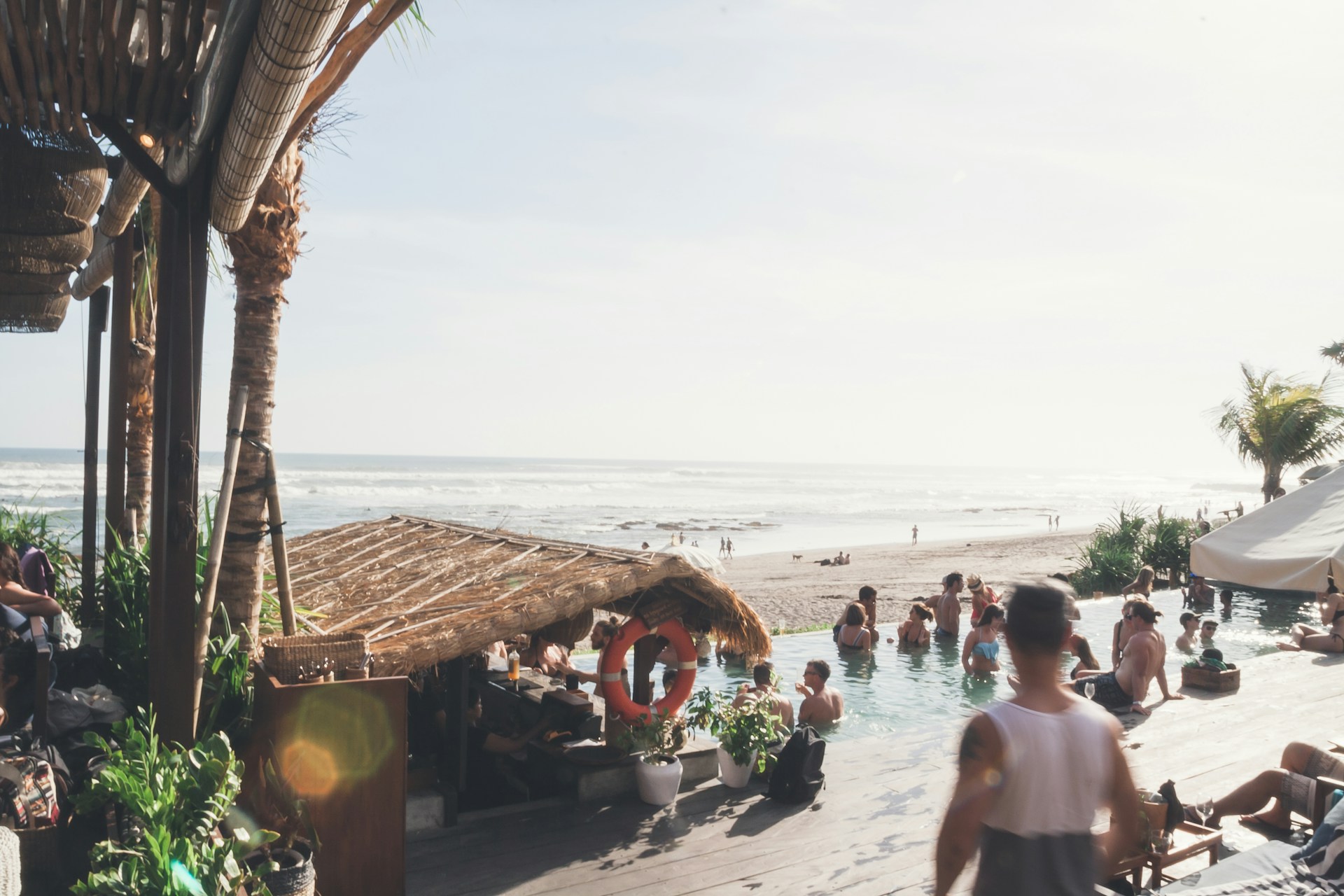 A lively pool party at a Riviera Maya all-inclusive hotel with guests enjoying drinks and music.