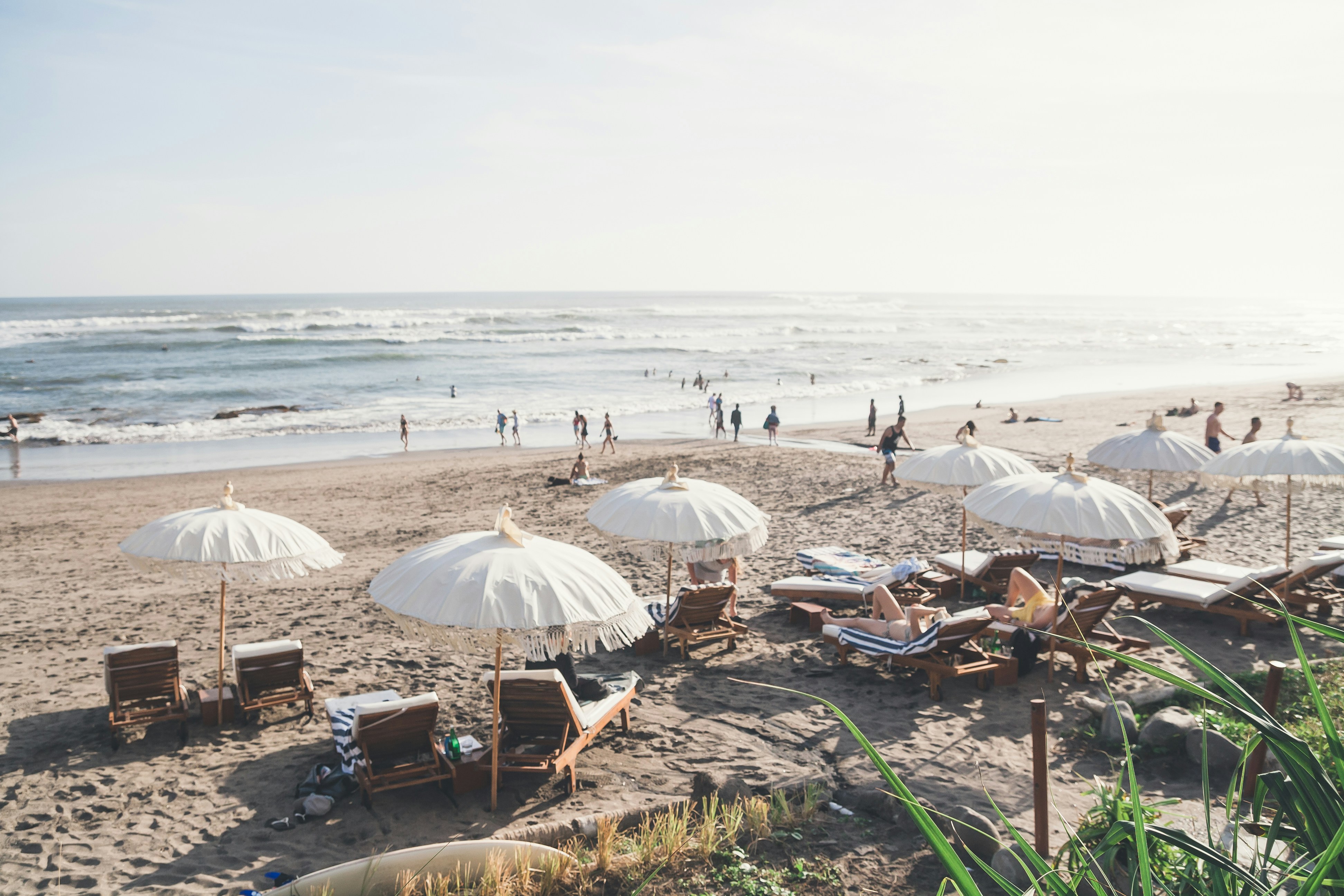 white umbrellas on beach shore during daytime