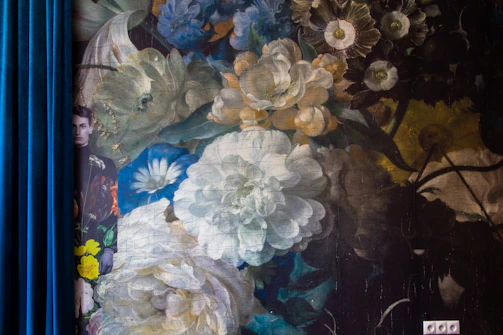 Close-up of a detailed floral mural printed on a bedroom wall.