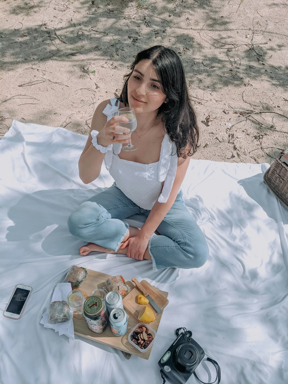 woman in white dress sitting on white textile