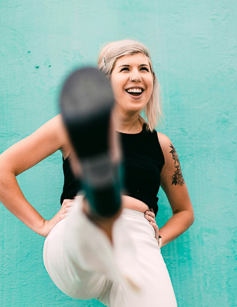 woman in black tank top smiling