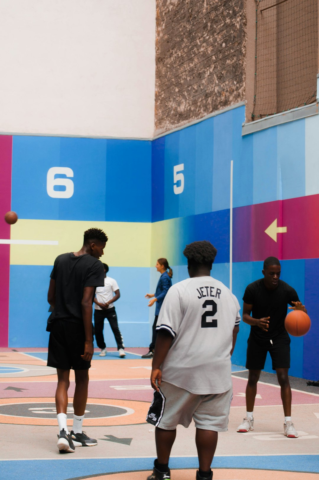 man in black and white nike jersey shirt and black shorts standing beside man in white