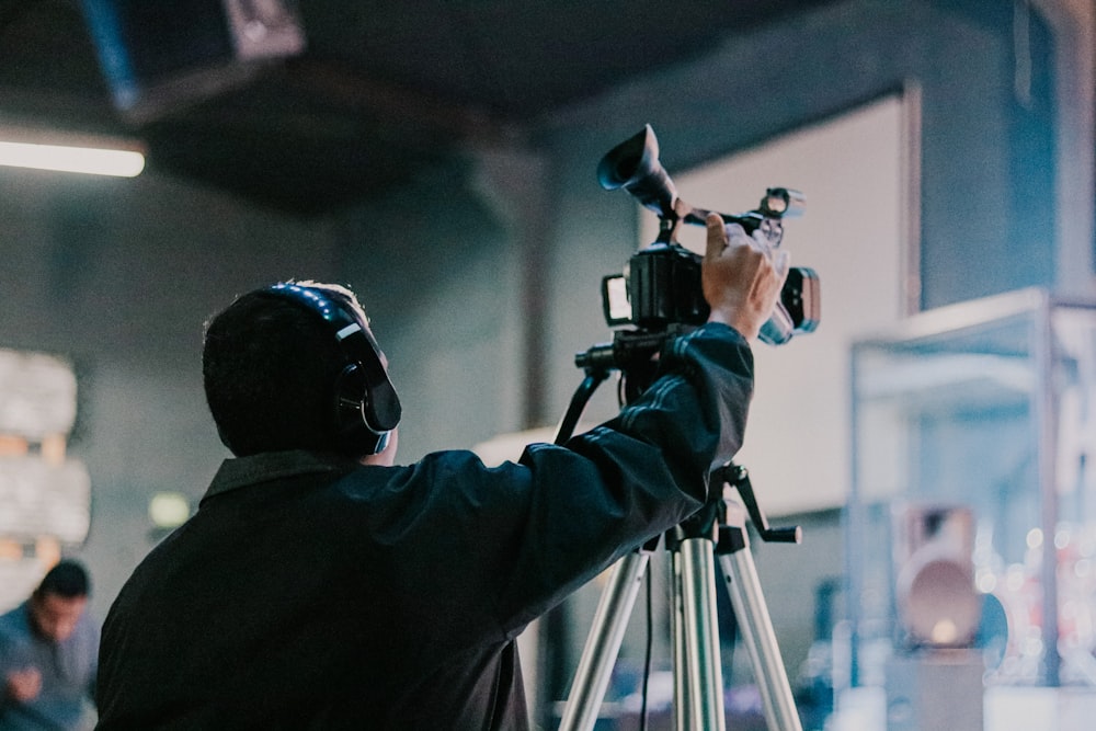 a man holding a camera up to take a picture