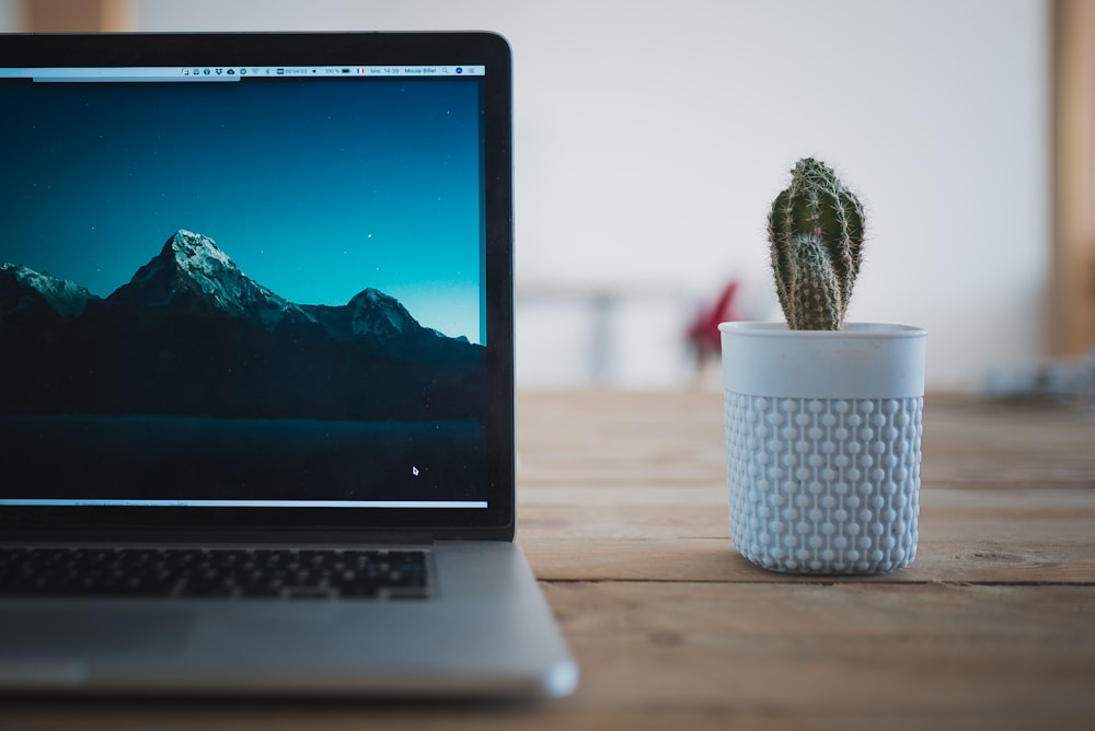 macbook pro on brown wooden table