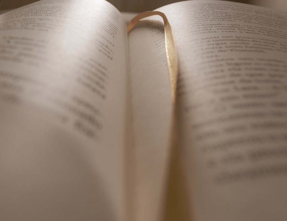 opened book on brown wooden table