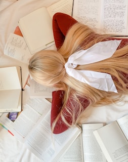 A candid shot of Tara studying late at night surrounded by books, embodying perseverance.