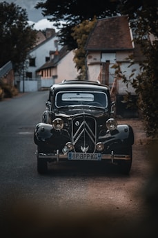 black vintage car parked on the side of the road during daytime