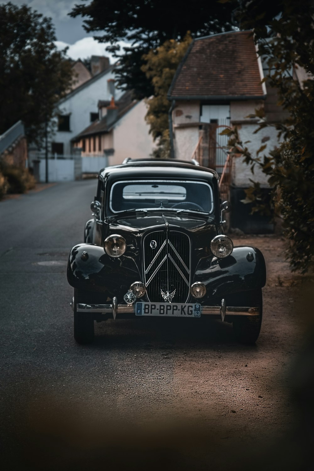 black vintage car parked on the side of the road during daytime