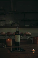 Softly lit scene of a personalized wine bottle beside a handwritten note and a glass half full.
