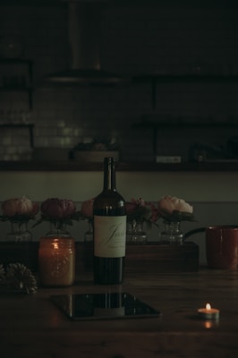 A close-up of a wine bottle with an NFC chip glowing softly, surrounded by warm candlelight.