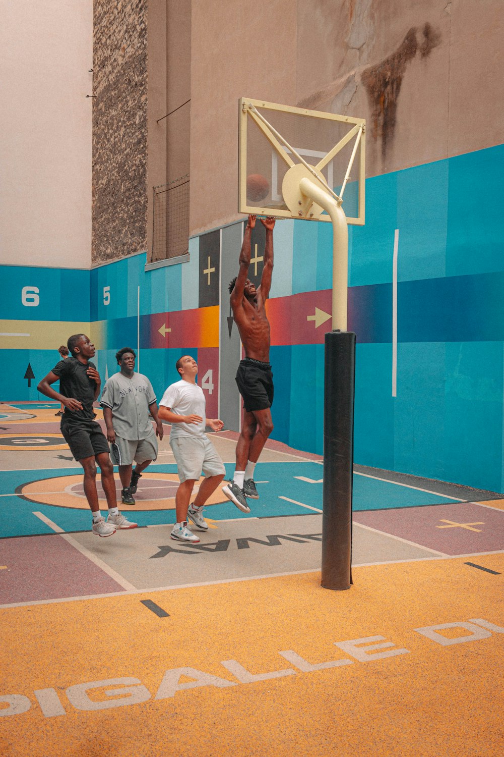 a group of young men playing a game of basketball