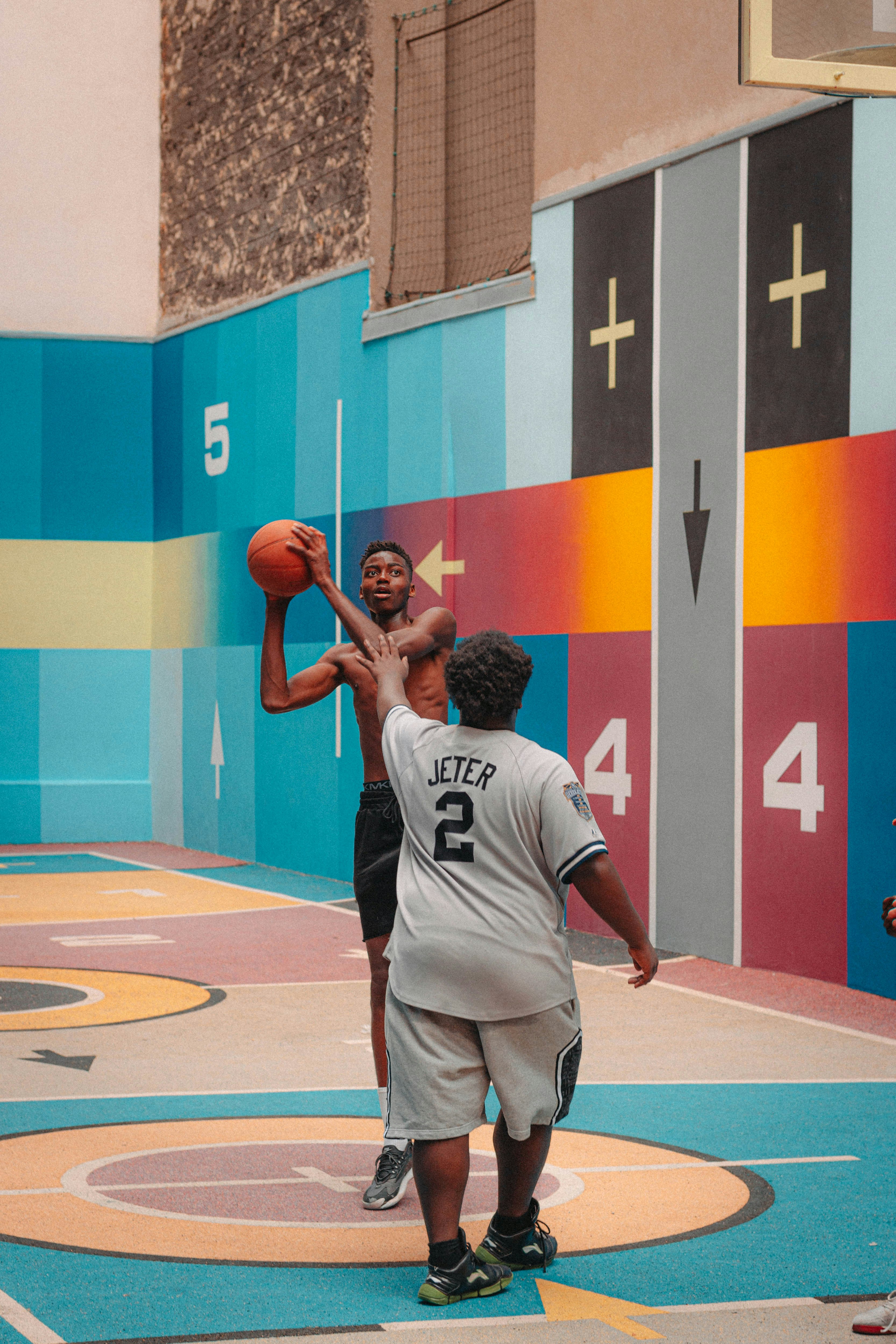 man in white jersey shirt and shorts playing basketball