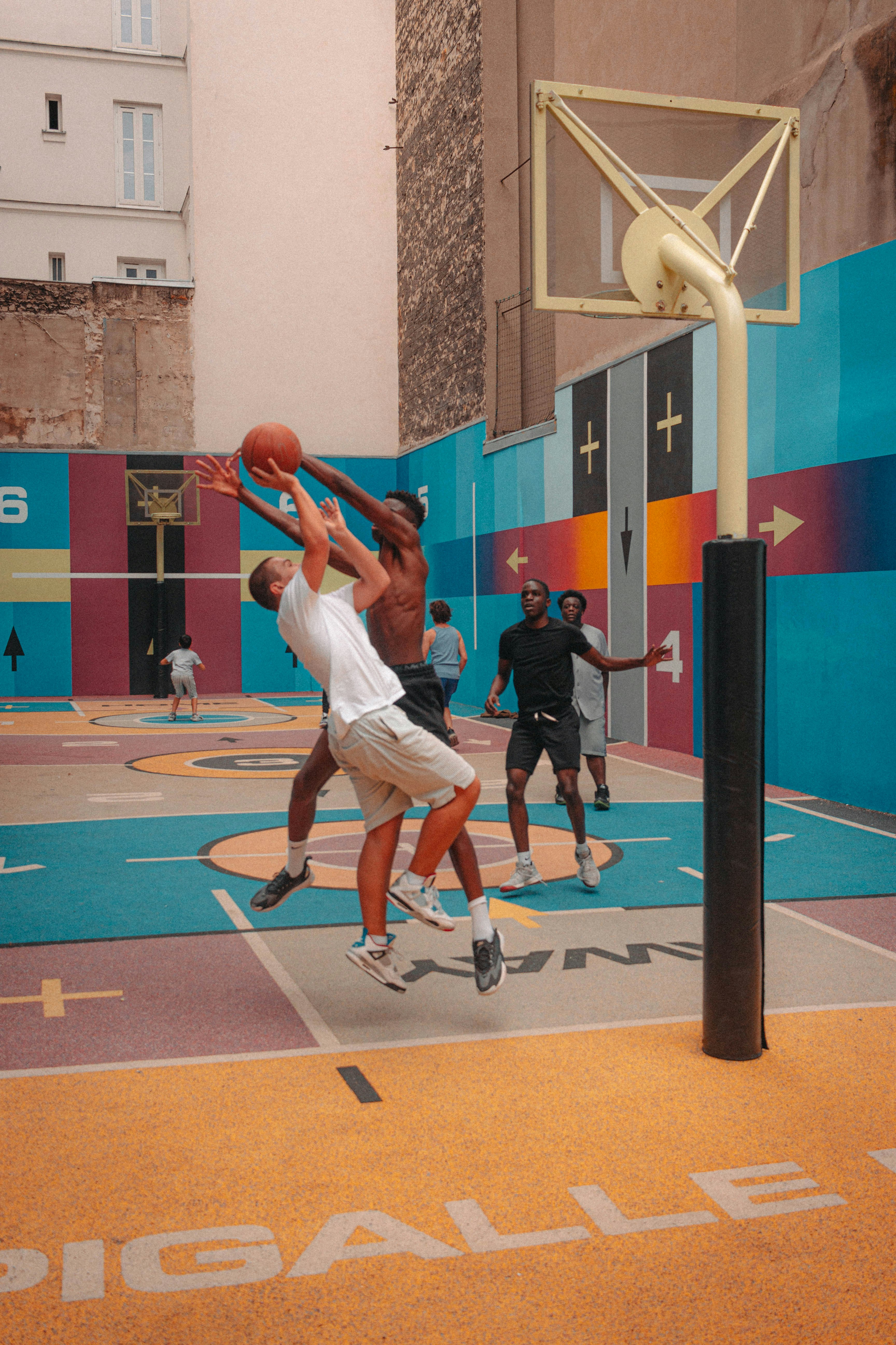 man in white shirt and white shorts playing basketball