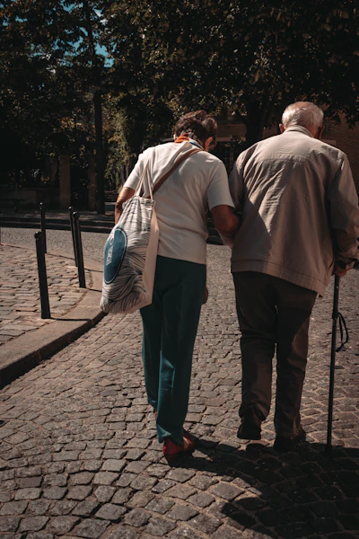 A caregiver standing beside a client, ready to help