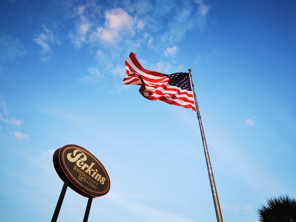 us a flag on pole under blue sky during daytime