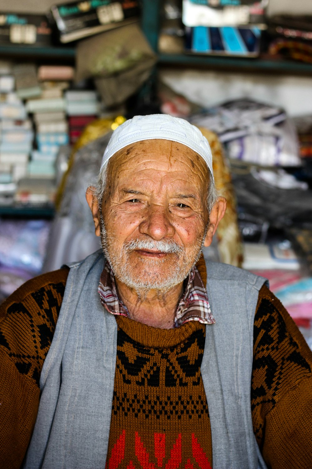 man in white and brown hat and gray vest