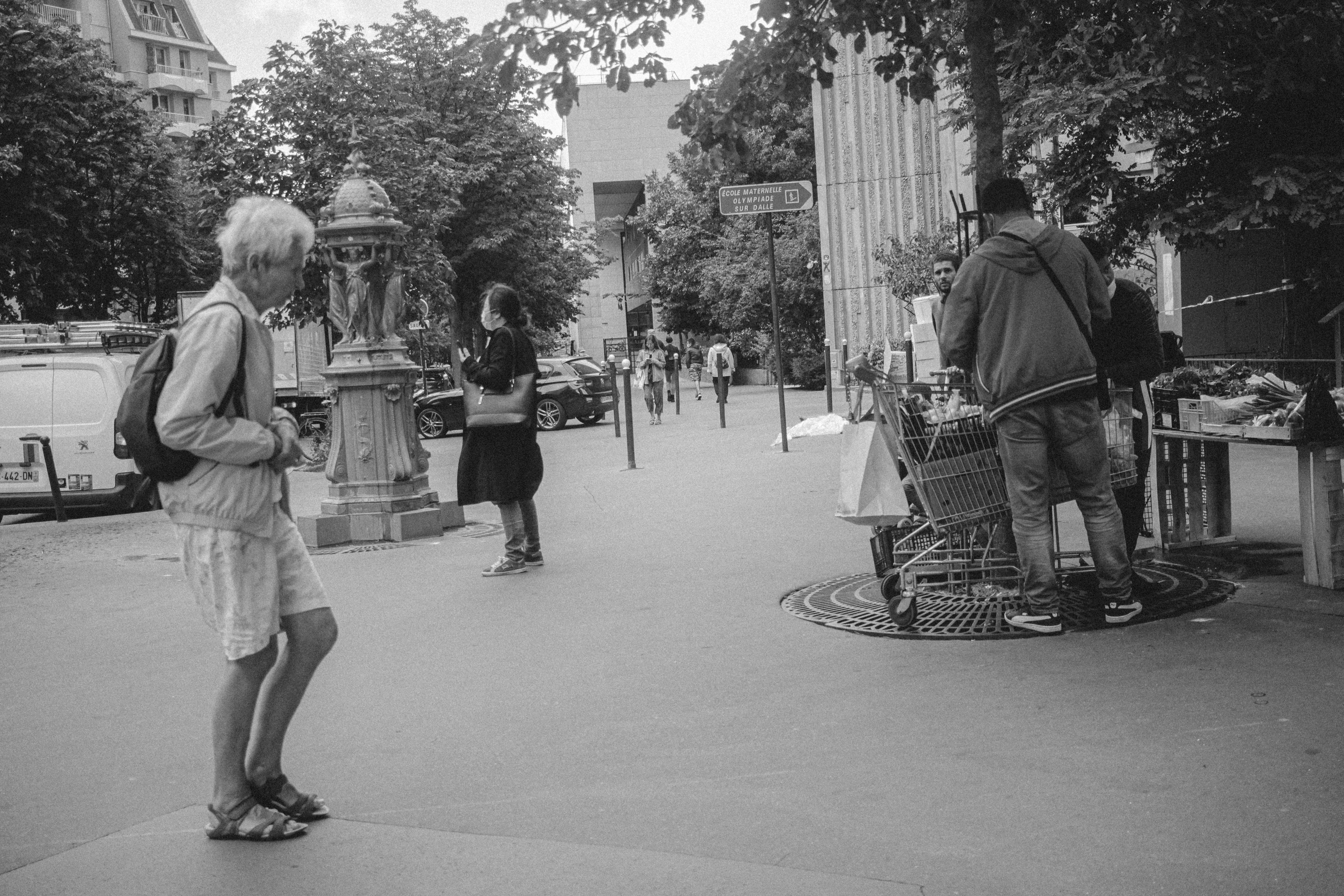 a black and white photo of people on a city street