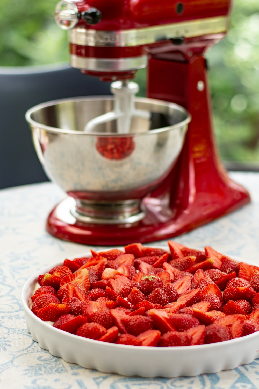 red sliced fruits on stainless steel bowl