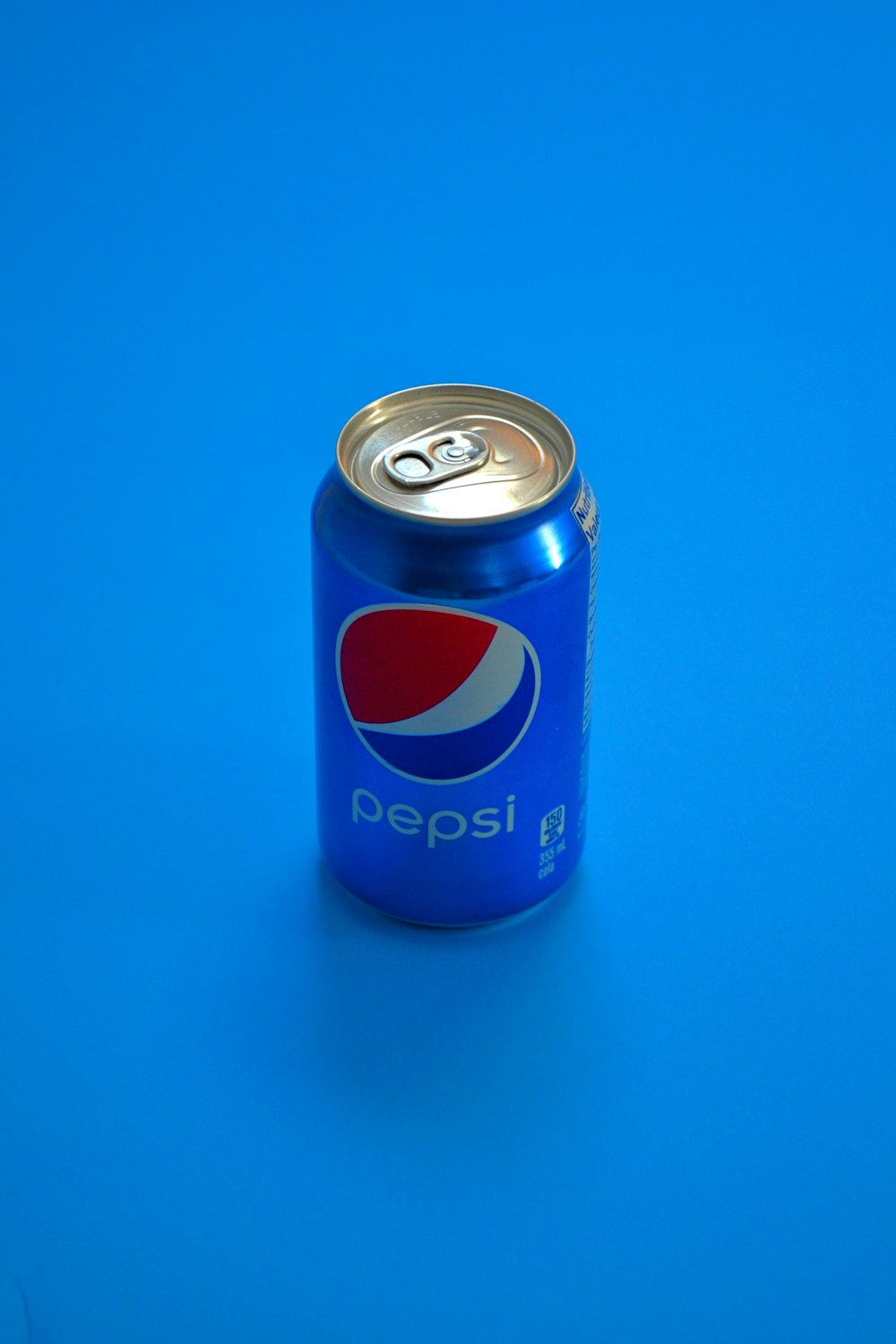 pepsi can on blue surface