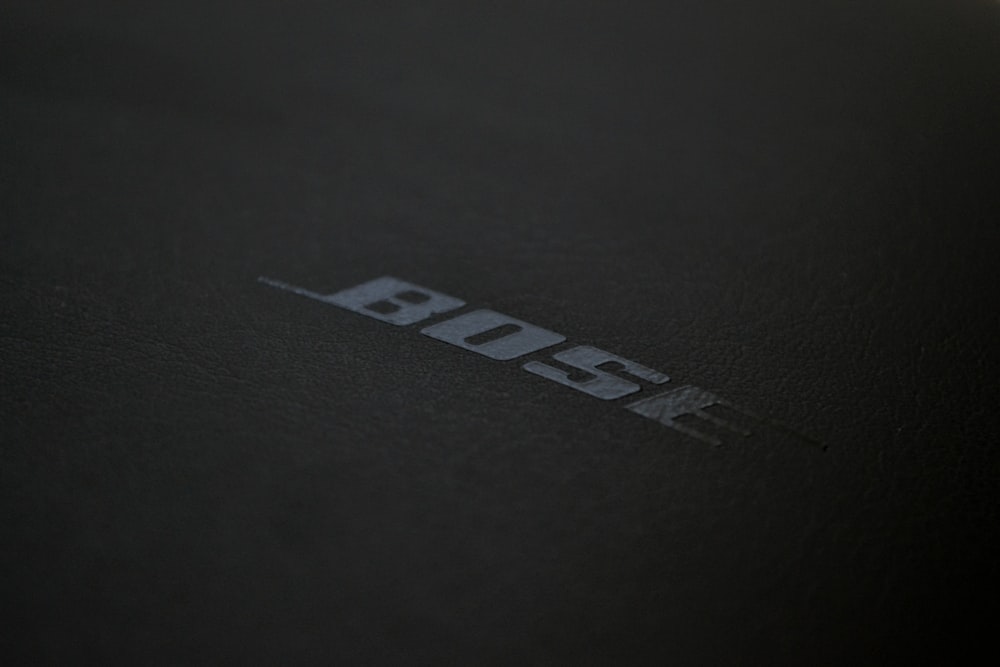 a close up of the logo on a black surface