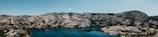 A panoramic view of mountains reflecting in a serene lake.