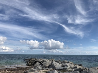 A serene seaside property with panoramic ocean views under a clear blue sky.