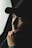 man in black hat grayscale photo