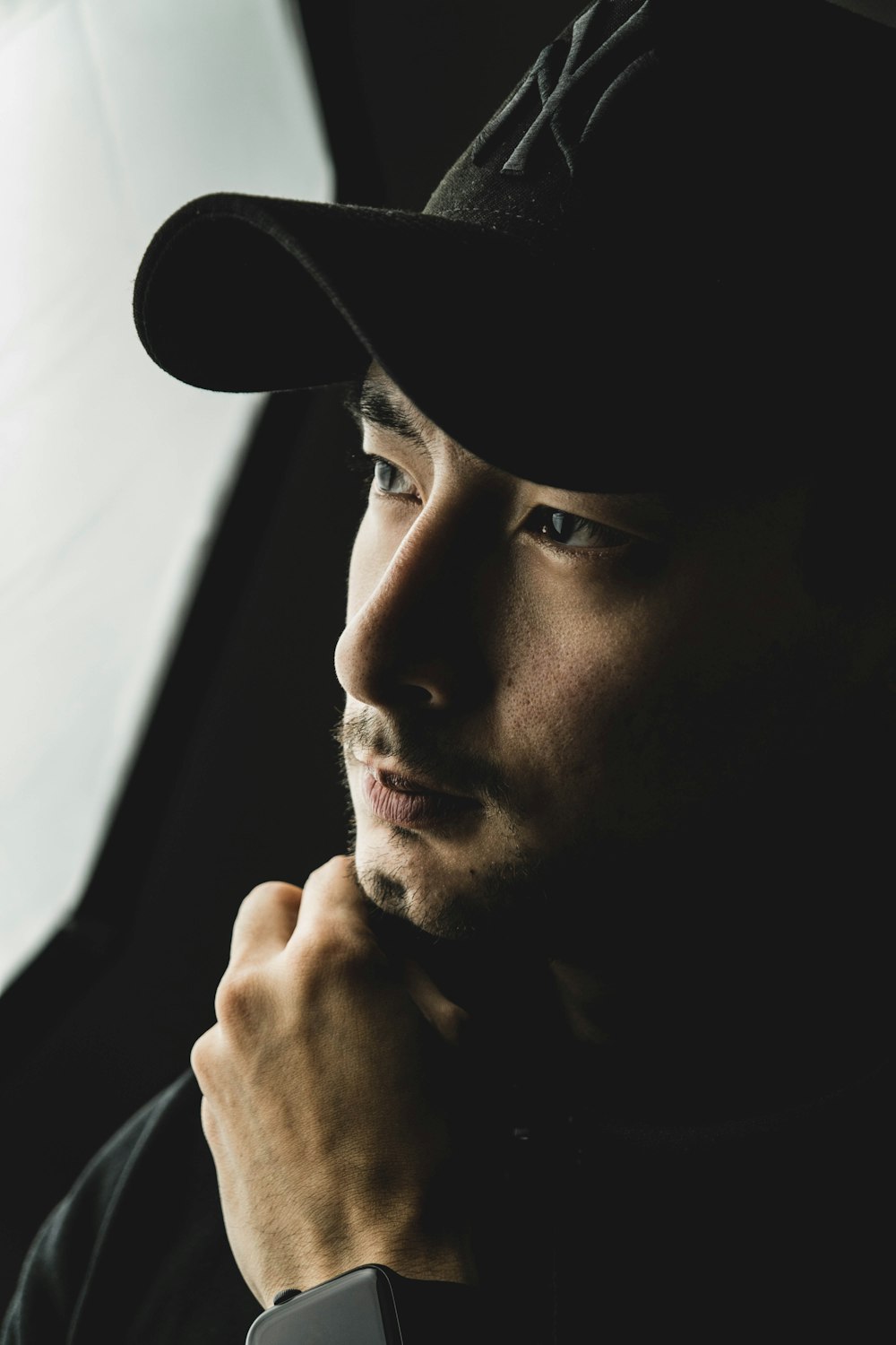 man in black hat grayscale photo